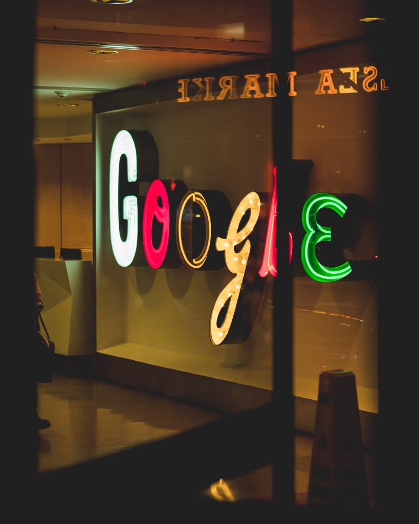 Google Sign inside a building lobby lit up at night